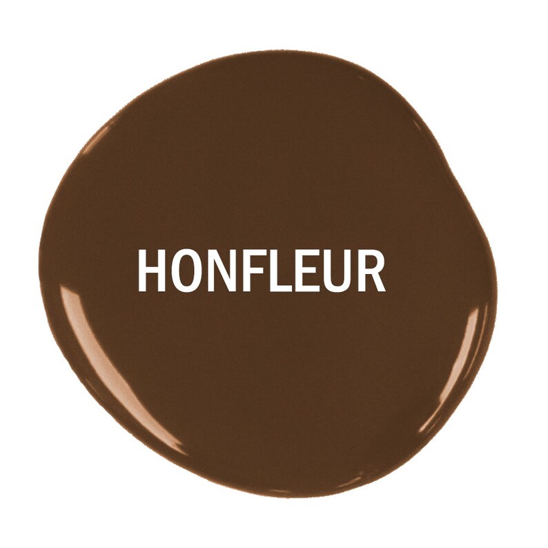 May include: A close-up of a brown paint swatch with the word "Honfleur" written in white text.