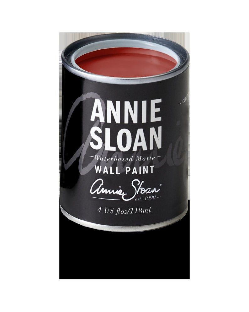 May include: A small can of Annie Sloan Chalk Paint in a deep red color. The can is labeled "Annie Sloan Waterbased Matte Wall Paint" and has the company logo and "4 US fl oz/118ml" printed on the bottom.