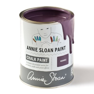 May include: A can of Annie Sloan Chalk Paint in the colour Rodmell. The paint is a deep purple colour and is shown with a drip running down the side of the can. The can has a white label with the Annie Sloan logo and the words "Chalk Paint" and "Rodmell".
