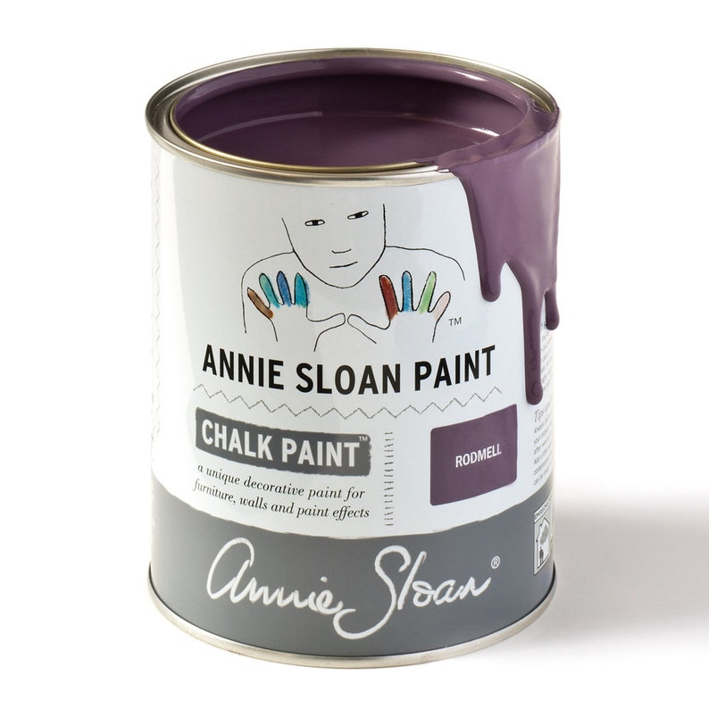May include: A can of Annie Sloan Chalk Paint in the colour Rodmell. The paint is a deep purple colour and is shown with a drip running down the side of the can. The can has a white label with the Annie Sloan logo and the words "Chalk Paint" and "Rodmell".