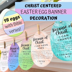May include: A banner of 18 Easter eggs decorated with Bible verses. Each egg is a different color and has a different verse written on it. The banner is strung with twine and clothespins. The eggs say "Because of Christ... I can be healed", "Because of Christ... I can pray for what I need", "Because of Christ... I will live again", "Because of Christ... I can have hope", and "Because of Christ... I can change".