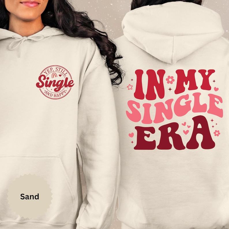 May include: A white hoodie with a red and pink graphic on the front that says "Yep, Still Single and Happy" and a red and pink graphic on the back that says "In My Single Era".