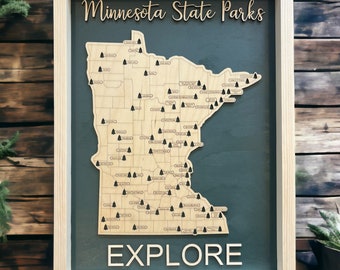 May include: A wooden map of Minnesota with the names of all the state parks printed on it. The map is framed in a light wood frame and has a dark green background. The word "EXPLORE" is printed in large letters at the bottom of the map.