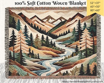 May include: A woven cotton throw blanket featuring a colorful landscape scene with mountains, a river, and trees. The blanket is available in three sizes: 52 inches by 37 inches, 60 inches by 50 inches, and 80 inches by 60 inches.