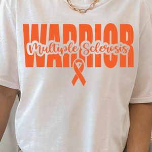 May include: White t-shirt with the word "WARRIOR" in orange block letters above "Multiple Sclerosis" in a script font. An orange awareness ribbon is below the text. The shirt is worn with ripped jeans.