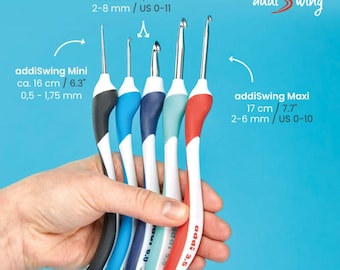 May include: Five addiSwing crochet hooks in different sizes and colors. The hooks are held in a hand. The hooks are labeled with their sizes in millimeters and inches. The hooks are labeled addiSwing Mini and addiSwing Maxi.