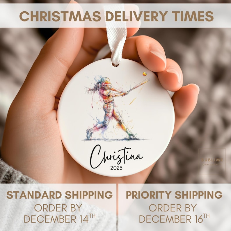 May include: White ceramic baseball ornament with a watercolor illustration of a batter swinging. The ornament has the name "Christina" and the year "2025" in a script font. A white ribbon is attached for hanging.