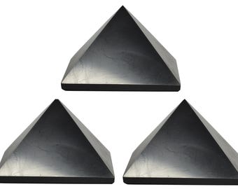 May include: Three black obsidian pyramids, each with a smooth, polished surface. The pyramids are arranged in a triangular formation.