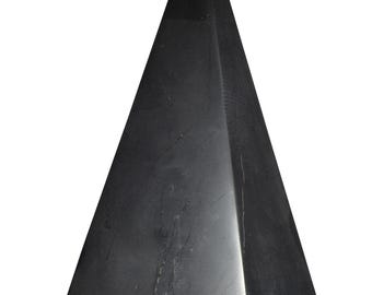 May include: A solid black pyramid with a pointed top. The pyramid has a smooth, polished surface with subtle variations in tone. The geometric shape stands on a white background, highlighting its form and texture.