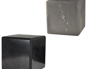 May include: Two black marble cubes of different sizes. The larger cube has a lighter gray marbling pattern.