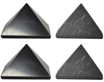 May include: Four black obsidian pyramids, two with a smooth surface and two with a veined surface.