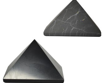 May include: Two black obsidian pyramids, one larger than the other, with a smooth, polished surface. The pyramids are made of natural black obsidian, a volcanic glass.
