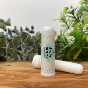 May include: White plastic tube with a green and white label that says "Brain Boost Aroma Inhaler".