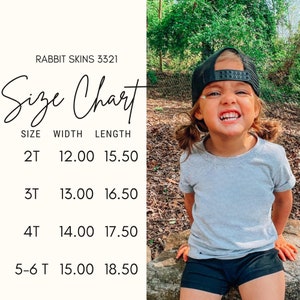 May include: A child wearing a gray t-shirt and black shorts smiles, with a black cap. A size chart displays measurements for children's t-shirts, including width and length in inches, for sizes 2T to 5-6T. The text "RABBIT SKINS 3321" is at the top.