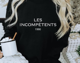 May include: Black sweatshirt with white text that reads "LES INCOMPÉTENTS 1990".