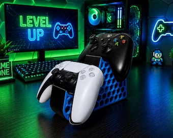 May include: A blue 3D-printed honeycomb-patterned controller stand holding a white and black game controller in the front and a black game controller in the back. The stand features a geometric hexagonal structure designed to support two gaming controllers.