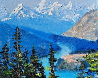 May include: An oil painting depicts a mountain landscape with snow-capped peaks, a blue lake, and evergreen trees in the foreground. The sky is a light blue, and the painting has a textured, impressionistic style.