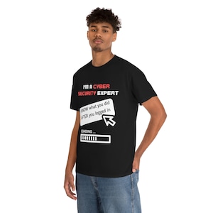 May include: A black t-shirt with a white graphic that says "I'm a Cyber Security Expert" and a white box with the text "KNOW what you did AFTER you logged in" and a white mouse cursor. Below the box is a white progress bar with the text "LOADING..."