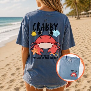 May include: Blue t-shirt with a crab graphic and the text "if crabby please return to the beach." The crab is red with black eyes and is surrounded by a sun, seashell, starfish, and sunglasses. A smaller version of the shirt is in the corner.