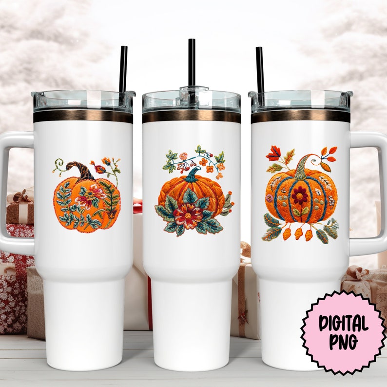 Peut inclure: Trois gobelets en acier inoxydable blanc avec couvercles et pailles. Chaque gobelet pr&eacute;sente un motif brod&eacute; de citrouille avec des accents floraux. Les citrouilles sont orange avec des tiges brunes et des feuilles vertes. Les accents floraux sont dans des tons de rouge, orange, jaune, vert et bleu.