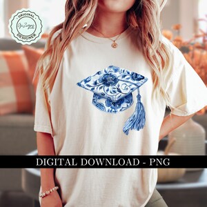May include: A white t-shirt with a blue and white floral graduation cap design. The cap has a tassel and is centered on the shirt. The text "DIGITAL DOWNLOAD - PNG" is at the bottom of the image.