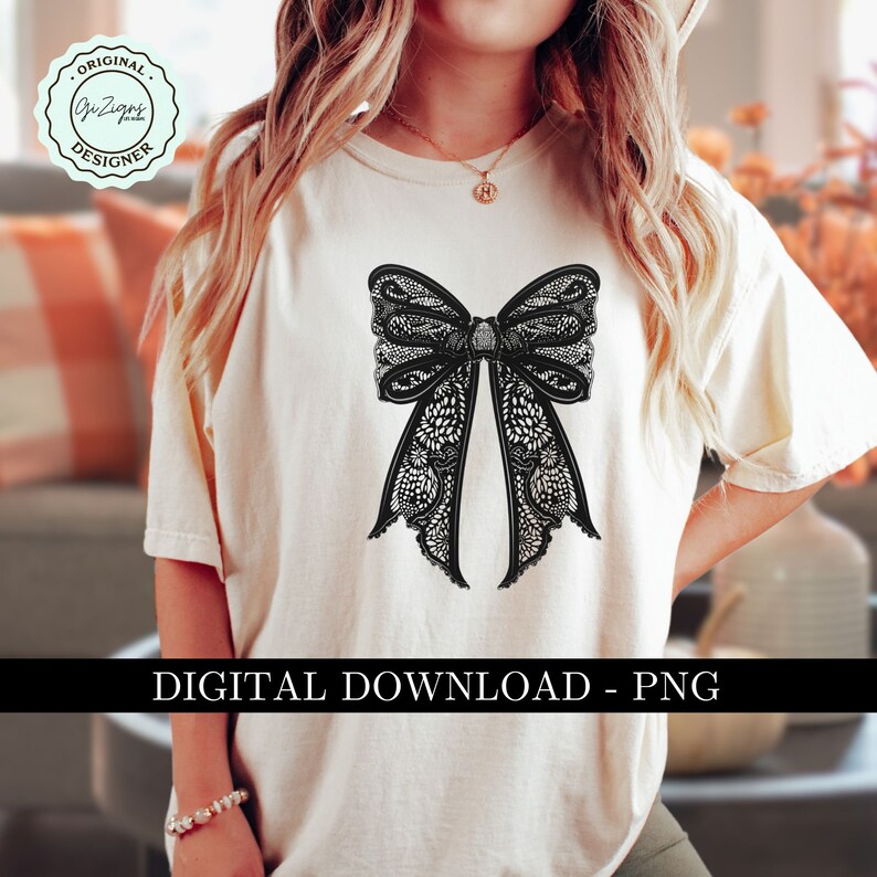 May include: A white t-shirt with a black lace bow design. The design is intricate and detailed, with a delicate floral pattern. The shirt is a simple, classic style, perfect for everyday wear.