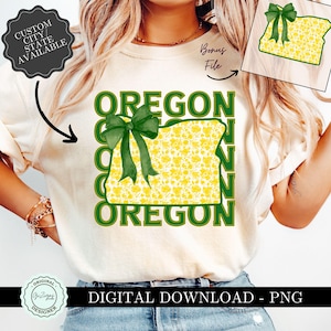 May include: Cream-colored t-shirt featuring the word "OREGON" in green, with a yellow floral-patterned Oregon state outline and a green bow. The text "DIGITAL DOWNLOAD - PNG" is at the bottom. A bonus file is included.