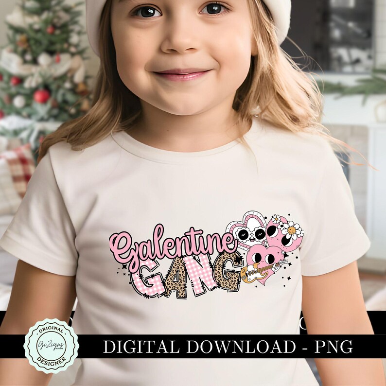 May include: A white t-shirt with a pink and black graphic design that says "Galentine Gang". The graphic features a heart with a face and a guitar.