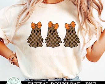 May include: A white t-shirt with three brown and white checkered ghosts wearing orange bows. The ghosts are in a row and have a cute, cartoon-like appearance. The text "DIGITAL DOWNLOAD - PNG" is at the bottom of the image.
