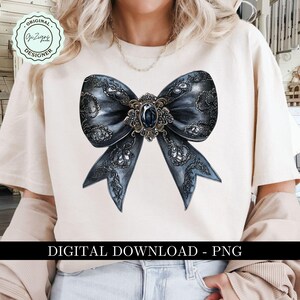 May include: A digital download of a black and silver bow with a large jewel in the center. The bow is on a white background.  The text "DIGITAL DOWNLOAD - PNG" is at the bottom of the image.