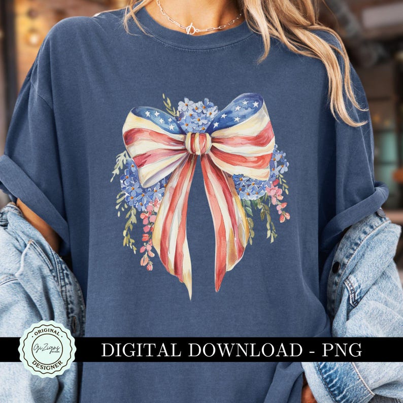 May include: A navy blue t-shirt with a watercolor design of a red, white, and blue bow with flowers. The bow is made to look like the American flag. The text "DIGITAL DOWNLOAD - PNG" is at the bottom of the shirt.