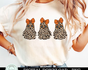 May include: A white t-shirt with three orange and brown leopard print ghosts wearing orange sunglasses and orange bows. The text "DIGITAL DOWNLOAD - PNG" is at the bottom of the image.