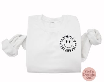 Moletom gola redonda com carinha sorridente, estilo retrô com boas vibrações.