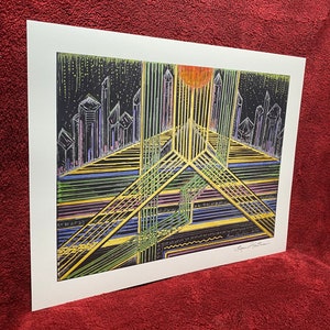 May include: A black and white abstract art print with a cityscape and geometric lines in shades of yellow, green, blue, and purple. The print is signed "Brent Sutphin 1973".
