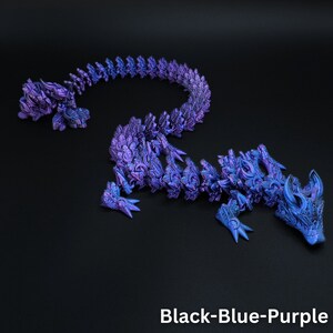May include: A flexible, articulated dragon figurine featuring a metallic, iridescent finish in shades of black, blue, and purple. The creature has a segmented body with intricate scale detailing, sharp claws, and horns. The text Black-Blue-Purple is visible.