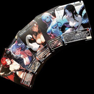 May include: A collection of collectible trading cards with anime-style illustrations of female characters. The cards feature various designs, including a swan, a blue-skinned woman, and a woman with tentacles. The cards are displayed against a black backdrop.