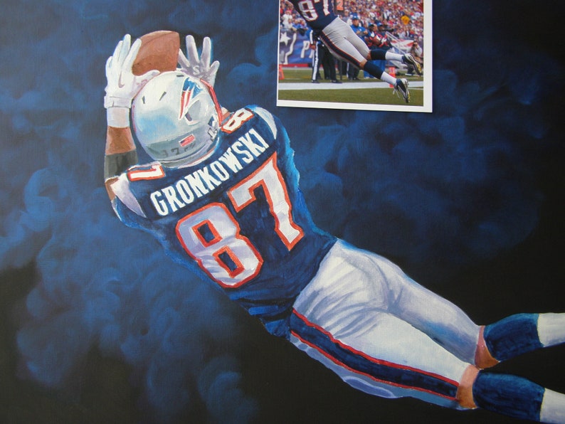 May include: An oil painting of a football player in a blue and white uniform, catching a football. The player's jersey displays the name "GRONKOWSKI" and the number "87". The background is a dark blue with lighter blue brushstrokes.