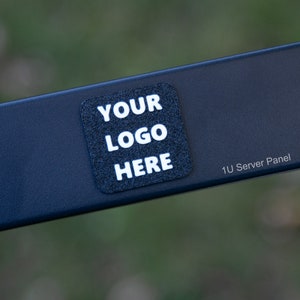 May include: A black 1U server panel with a white sticker that says "YOUR LOGO HERE".