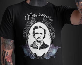 May include: Black t-shirt featuring a white illustration of Edgar Allan Poe within a decorative frame. The text "Nevermore" is written in a cursive font above the frame.
