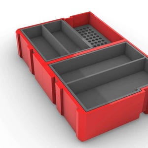May include: Red plastic storage box with multiple compartments. The box has a gray interior and a gridded section.