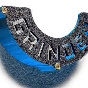 May include: A blue and black grinder with the word "GRINDER" printed on it.