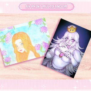 May include: Two A4 print art pieces on a wooden surface. One features a watercolor portrait of a woman with long orange hair and purple flowers. The other depicts a cartoon character with a crown. The text "A4 PRINT MULTIFANDOM" is at the top.
