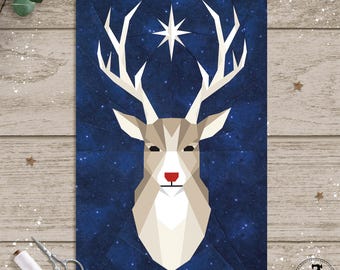 May include: A geometric design of a reindeer head with large antlers and a red nose, set against a dark blue starry background. The artwork is a paper craft, possibly a quilt pattern, with the Easy Piece Patterns logo in the lower right corner.