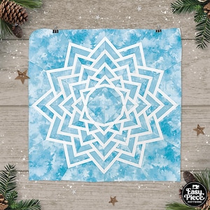 May include: A blue and white snowflake quilt block pattern with a watercolor background. The pattern is made up of multiple layers of triangles and squares.