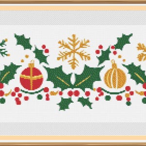 May include: A white background with a green holly garland with red berries, gold snowflakes, and gold and red ornaments.