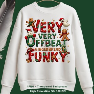 May include: White sweatshirt with a Christmas-themed design featuring gingerbread men, a snowman, and a ghost. The text reads "Very Very Offbeat Gingerbread Funky".