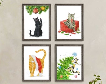 May include: Four framed watercolor cat art prints. Each print features a different cat in a Christmas theme. One black cat, one tabby cat in a gift box, one orange cat with a Santa hat, and one calico cat with a Christmas tree.