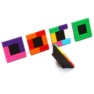 May include: Five colorful picture frames made of Lego bricks. The frames are in different colors, including red, orange, yellow, green, and purple. The frames are all the same size and shape, and they are all arranged in a row.