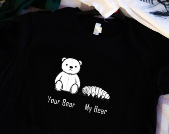 Puede incluir: Camiseta negra con un oso de dibujos animados blanco y un gusano blanco. El texto "Your Bear" está debajo del oso y "My Bear" está debajo del gusano.