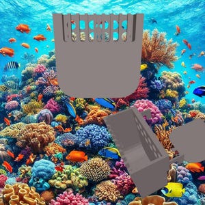 May include: A 3D printed model of a coral reef with a gray plastic fish tank divider. The divider has a rectangular shape with a series of holes in the top. The reef is made up of colorful coral and fish.